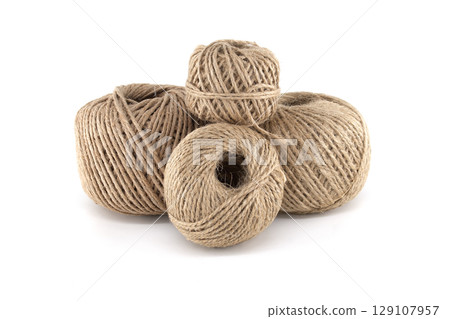 Close-up of four neatly arranged spools of natural twine, ideal for crafting and packaging. Close-up of four neatly arranged spools of natural twine, ideal for crafting and packaging. 129107957