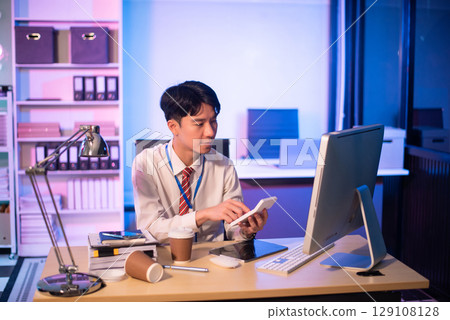 Overworked young Asian businesswoman office worker suffering from neck pain after had a long day at her office desk. Overworked young Asian businesswoman office worker suffering from neck pain after had a long day at her office desk. 129108128
