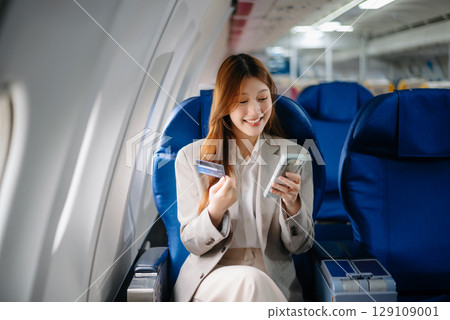 Asian Woman Working on Tablet During  in first class, multitasking with Flight Travel in style, work 129109001