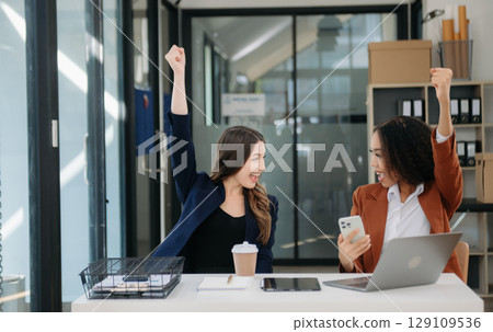 Business colleague business presents and explains and using laptop and tablet. Teamwork, financial marketing team, Business colleague business presents and explains and using laptop and tablet. Teamwork, financial marketing team, 129109536