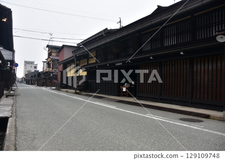 Old townscape of Takayama City, Gifu Prefecture, Japan. Old houses exuding a sense of history. Morning scene during the Takayama Spring Festival. Old townscape of Takayama City, Gifu Prefecture, Japan. Old houses exuding a sense of history. Morning scene during the Takayama Spring Festival. 129109748