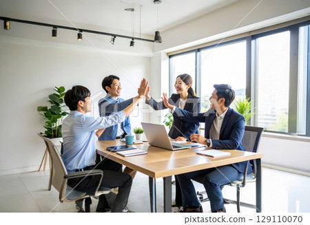 A business team celebrating their sales achievements A business team celebrating their sales achievements 129110070