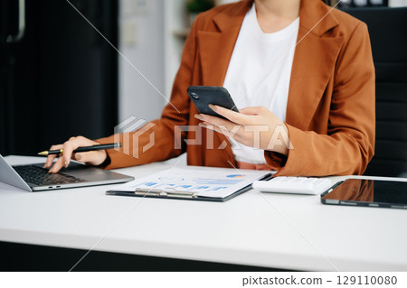 businesswoman hand working with new modern computer using on smartphone and tablet as concept 129110080