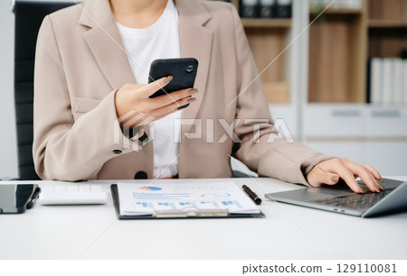 businesswoman hand working with new modern computer using on smartphone and tablet as concept 129110081