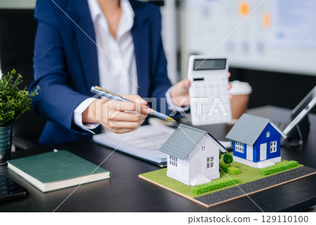 balancing the property sector The real estate agent is explaining the house style to see the house design and the purchase agreement. model house and comdo 129110100