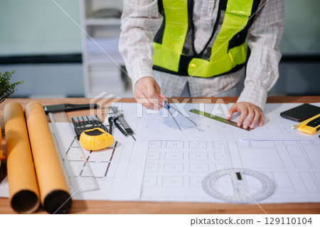 usiness people having consultation about wind energy at company office. on architectural project site and making model house. 129110104