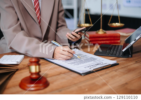 justice and law concept.law the desk, books, balance. male judge in a courtroom the gavel,working with digital tablet, smartphone 129110110