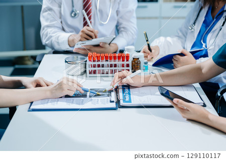 Medical technology network team meeting concept. Doctor hand working with smart phone modern digital tablet and laptop 129110117