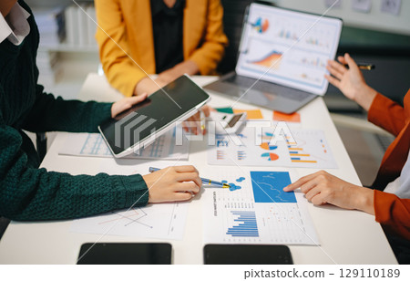 Business team meeting present.professional investor working with Finance managers task. with laptop smart phone Business team meeting present.professional investor working with Finance managers task. with laptop smart phone 129110189
