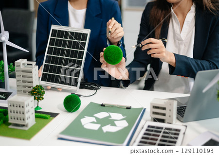 Group of alternative energy engineers discussing a project with a worker businesspeople a meeting in solar 129110193
