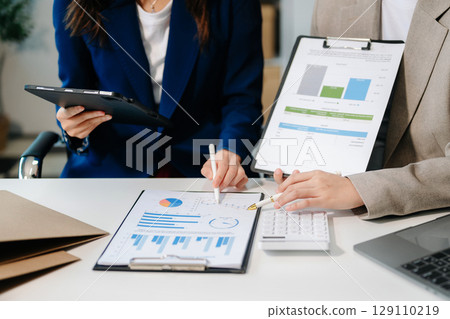 Businessman and team analyzing financial statement Finance task. with smart phone and laptop and tablet. Businessman and team analyzing financial statement Finance task. with smart phone and laptop and tablet. 129110219
