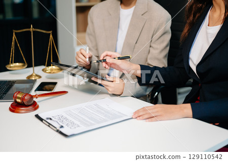 Business law concept, Lawyer business lawyers are consulting lawyers for women entrepreneurs to file copyright lawsuit with laptop and tablet 129110542