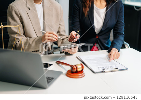 Business law concept, Lawyer business lawyers are consulting lawyers for women entrepreneurs to file copyright lawsuit with laptop and tablet 129110543
