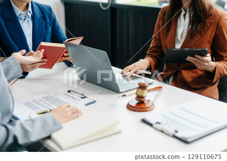 business people and lawyers discussing contract papers sitting at the table. Concepts of law, advice, legal services. 129110675