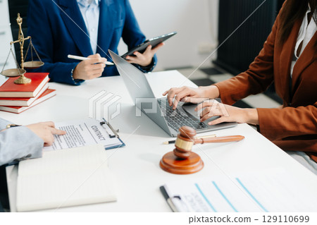 usiness team and Male lawyer or judge consult having team meeting with client, Law and Legal services concept. usiness team and Male lawyer or judge consult having team meeting with client, Law and Legal services concept. 129110699