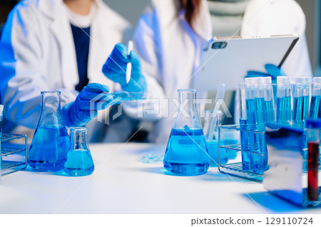Scientist team meeting and writing analysis results in the laboratory study and analyze scientific 129110724