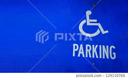 blue parking sign featuring a universal symbol for accessibility and the word PARKING. Highlights the availability of designated spaces for differently disabled individuals for convenience. blue parking sign featuring a universal symbol for accessibility and the word PARKING. Highlights the availability of designated spaces for differently disabled individuals for convenience. 129110768