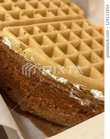 Crispy, golden waffles topped with creamy ice cream, creating a perfect balance of warm and cold, crunchy and smooth. A delightful dessert or breakfast treat, made even better with toppings like 129111653