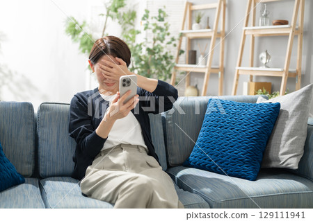 A woman holding a smartphone A woman holding a smartphone 129111941