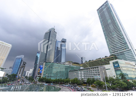 Jakarta, Indonesia - Mar 30,2024 :  View of Bundaran HI along Jendral Sudirman road in Jakarta, Indonesia on Mar 30,2024. 129112454