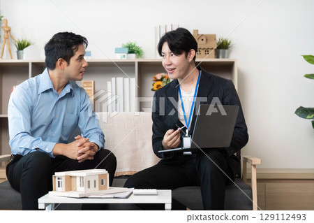 Real Estate Consultation. Professional meeting between agent and client discussing property investment. 129112493