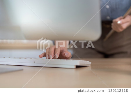 Remote Work. Professional woman typing on keyboard at home office desk. Remote Work. Professional woman typing on keyboard at home office desk. 129112518
