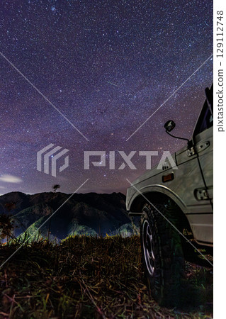 A meteor-streaked plateau sky and an off-road vehicle A meteor-streaked plateau sky and an off-road vehicle 129112748