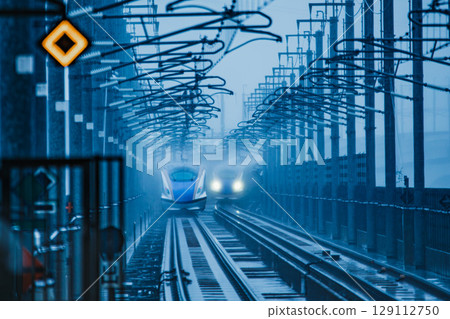 Two bullet trains passing each other in the rain Two bullet trains passing each other in the rain 129112750