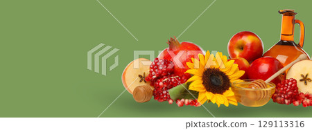 Apples, pomegranates, honey, and flowers, space for text 129113316