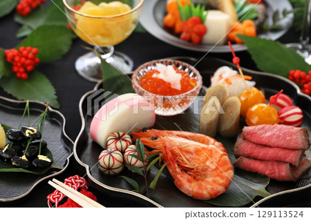 New Year's dishes served on a black plate 129113524