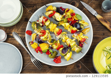 Delicious grilled fish and vegetables on wooden surface. Delicious grilled fish and vegetables on wooden surface. 129113595