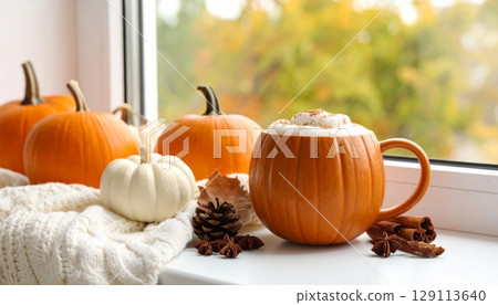 An orange autumn pumpkin and fresh pumpkin mug of coffee An orange autumn pumpkin and fresh pumpkin mug of coffee 129113640