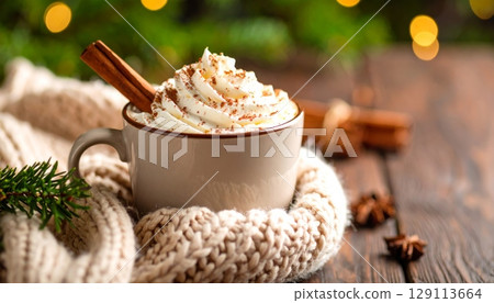 Coffee mug topping whipped cream with cinnamon sticks 129113664
