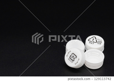 Plastic bottle cap on a black background 129113742