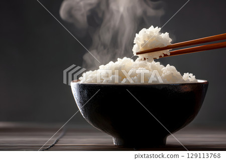 Freshly cooked stockpiled rice. A close-up of a bowl of steaming, delicious white rice. 129113768