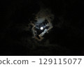 The moon shining in the night sky and illuminated clouds 129115077
