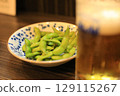 Enjoying edamame and beer at an izakaya 129115267