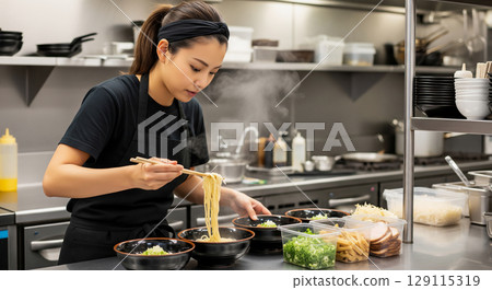 A woman at a ramen shop serves ramen 129115319