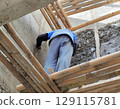 construction worker installing insulation of house 129115781