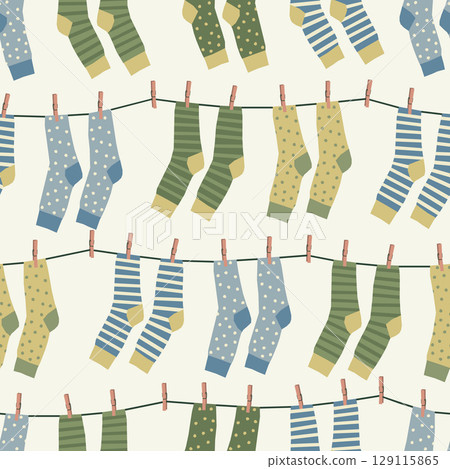 Vector seamless pattern with bright socks drying on a rope 129115865