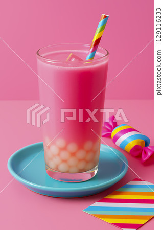 Bright pink fruit drink with tapioca balls at the bottom. Bright background, cooling drink. 129116233
