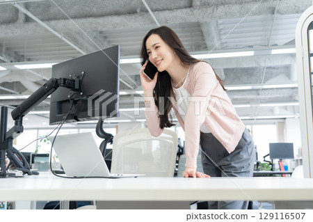 Young female engineer in office casual wear Young female engineer in office casual wear 129116507