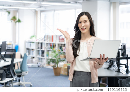 Young female engineer in office casual wear Young female engineer in office casual wear 129116513