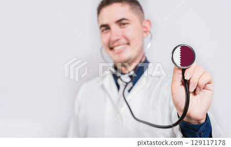 Doctor showing stethoscope with Qatar flag. Qatar national healthcare concept Doctor showing stethoscope with Qatar flag. Qatar national healthcare concept 129117178