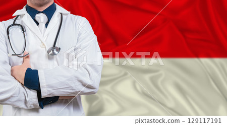 Male doctor with stethoscope on Indonesia flag. Doctor holding stethoscope on Indonesia flag Male doctor with stethoscope on Indonesia flag. Doctor holding stethoscope on Indonesia flag 129117191
