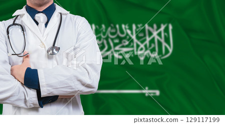 Male doctor with stethoscope on Saudi Arabia flag. Doctor holding stethoscope on Saudi Arabia flag 129117199