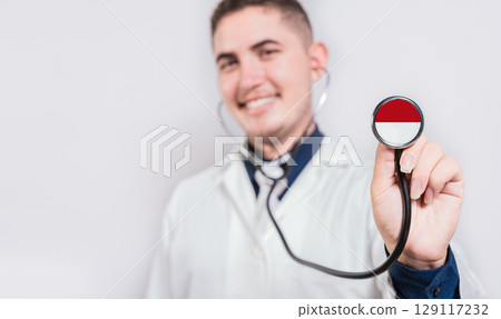 Doctor showing stethoscope with Monaco flag. Monaco national healthcare concept 129117232