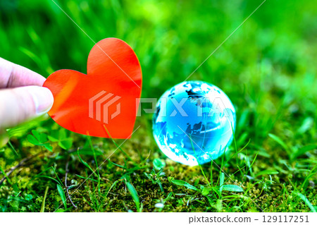 Holding a crystal globe and a heart in your hand - Ecology image 129117251