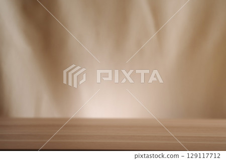 A simple wooden table with a beige backdrop, symbolizing minimalistic living. Uncluttered presentation for stylish concepts. A simple wooden table with a beige backdrop, symbolizing minimalistic living. Uncluttered presentation for stylish concepts. 129117712