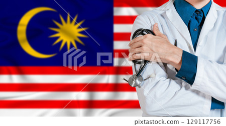 Doctor with stethoscope on Malaysia flag. Doctor holding stethoscope on Malaysia flag 129117756